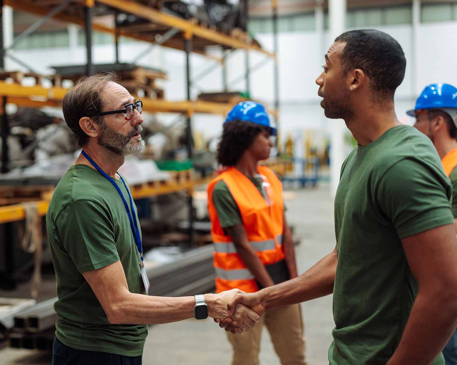 distributors shaking hands warehouse